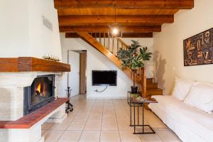 a living room with a couch and a fireplace at L'Oasis de SaBen - Piscine Privée in Belfort-du-Quercy
