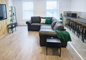 a living room with a couch and a table at Williamson Suites - Apartment 1 in Liverpool