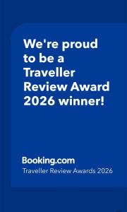 a blue sign that says were proud to be a traveller review award winner at Stay with the Singhs in Rolleston