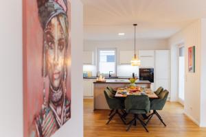 a kitchen and a dining room with a table and chairs at Penthouse `Wolke 7` am See mit Sauna in Lembruch