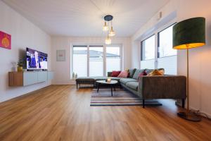 a living room with a couch and a table at Penthouse `Wolke 7` am See mit Sauna in Lembruch