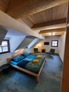 a bedroom with a large bed in a attic at Penzion Vejrovna in Přední Výtoň
