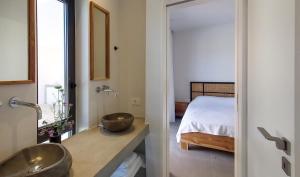 a bathroom with two sinks and a bed at Villa Anna in Paleros +33 photos