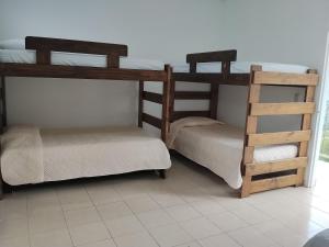 two bunk beds are sitting in a room at Apartamento Rústico Moderno in Ruiosucio