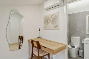 a bathroom with a wooden table and a toilet at Moradia Bar Sela, By Home Match in Setúbal +13 photos