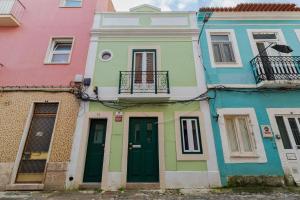 a row of colorful houses in a street at Moradia Bar Sela, By Home Match in Setúbal
