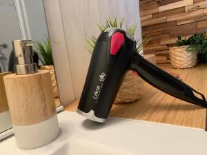 a black hair dryer sitting on a counter next to a knife at Le Studio du centre - 2-4p - 80 m de la plage in Les Sables-d'Olonne