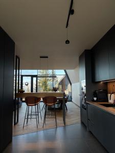 a kitchen and dining room with a table and chairs at TwoTop-Premium Chalet Villa with mountain view in Piatra Fantanele