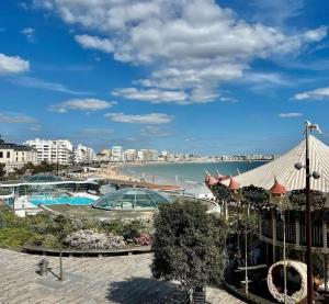 a view of the beach from the balcony of a resort at Le Studio du centre - 2-4p - 80 m de la plage in Les Sables-d'Olonne