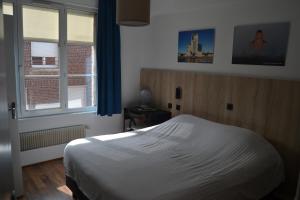 a bedroom with a white bed and two windows at Entre Nous in Rozoy-sur-Serre +27 photos