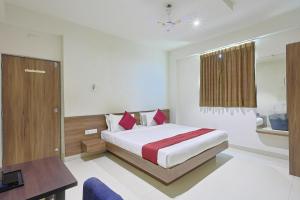 a bedroom with a bed and a table and a desk at The Castle Crown - Hotel Scintilla, Somnath in Somnath