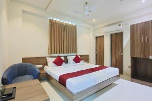 a bedroom with a bed and a desk and a television at The Castle Crown - Hotel Scintilla, Somnath in Somnath
