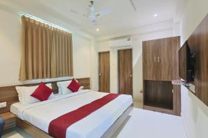 a hotel room with a bed and a television at The Castle Crown - Hotel Scintilla, Somnath in Somnath