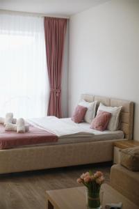 a bed in a room with a window at AVA Studio Sinaia in Sinaia +49 photos