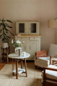 a living room with a table and a couch at Katrina Summer House in Jūrmalciems