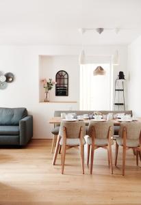 a living room with a table and a couch at HOMEBOUND APARTMENTS Salzburg City I - contactless check-in in Salzburg