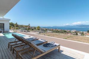 a patio with a table and chairs and the ocean at Villa Anna in Paleros