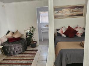 a bedroom with a bed and a chair in it at Escape Root in Caledon