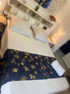 a bedroom with a large bed with leaves on it at LA PAILLOTE D OR in Sainte-Anne