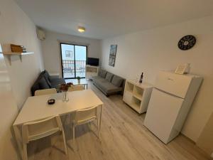 a kitchen and living room with a table and a refrigerator at Theodoros Apt.79 in Paralimni
