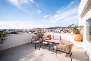 a patio with chairs and a table on a balcony at Apuntadores 8 in Palma de Mallorca
