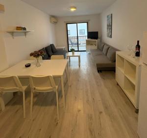 a living room with a table and a couch at Theodoros Apt.79 in Paralimni +2 photos