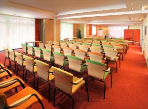 a room with rows of chairs and a podium at Land-gut-Hotel Zum alten Forsthaus - Aufladestation für Elektroautos in Hürtgenwald +144 photos