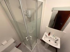a bathroom with a shower and a sink and a toilet at Core Citi Lets, Guild Street Rooms in Aberdeen