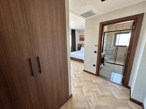 a room with a door and a bedroom with a bed at Plaza Residence in Tuzla