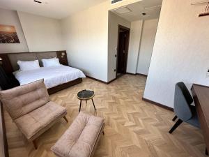 a hotel room with a bed and a couch at Plaza Residence in Tuzla