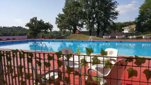 a large swimming pool with a fence around it at El Nou Roquet in Tavernoles