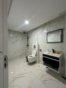 a bathroom with a toilet and a sink at appartment igar azougagh elhoceima in Al Hoceïma +251 photos