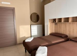 a bedroom with two beds and a mirror at RiVaLoVE in Nerviano