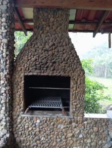 a large stone pizza oven with at Casa Recanto do Sossego in Antonina
