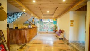a hallway with a wooden ceiling and a staircase at Bamboo Retreat Hotel in Gangtok