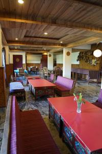 a large room with red tables and couches in it at Bamboo Retreat Hotel in Gangtok
