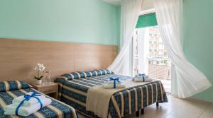Llit o llits en una habitació de Bahamas Residence & Spa