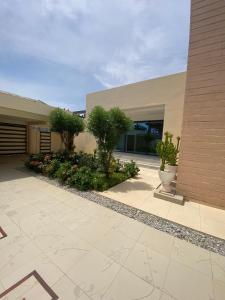 a building with a courtyard with trees and plants at Le grand luxe in Cotonou