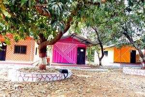 a building with a tree in front of it at Nivant Agro Experience in Gorhe