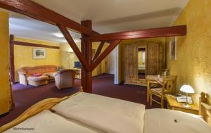 a bedroom with a bed and a living room at Hotel Gut Voigtlaender in Blankenburg +41 photos