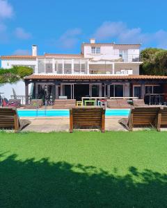 a house with a swimming pool in front of it at FreeSurfCamp in Peniche +32 photos