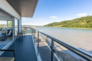 a balcony with a view of the river at River View - Prime River Front Location in Seaton