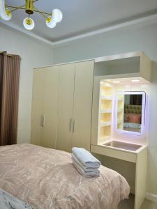 a bedroom with a bed and a window with towels at Serenity Stay in General Santos