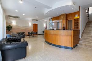 a lobby with a bar and some chairs and tables at Hotel Bridge in Rimini