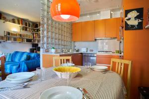a kitchen with a table with plates and bowls on it at My Home in Barcelona in Barcelona