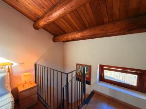a bedroom with a bed and a wooden ceiling at Lilla Stuga in Montenero Val Cocchiara