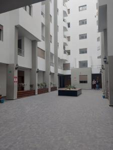 a large white building with people standing in the courtyard at Al Anouar 39B in Kenitra