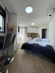 a bedroom with a bed and a desk and a computer at Villa Laverna Annex in Novalja +17 photos