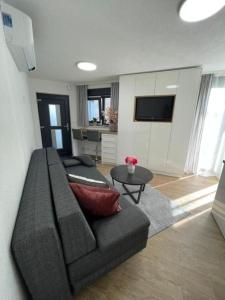a living room with a couch and a table at Villa Laverna Annex in Novalja