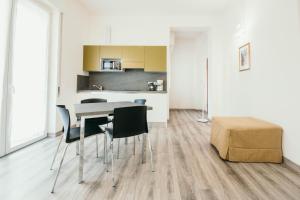 a kitchen and dining room with a table and chairs at AL 13 - Lakeside Leisure & Business in Stresa